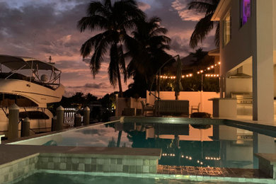 Mid-sized trendy backyard rectangular hot tub photo in Miami