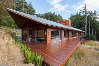 Large contemporary brown split-level wood exterior home idea in Vancouver with a metal roof