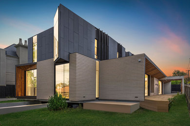 Expansive contemporary two-storey concrete grey house exterior in Melbourne with a flat roof.