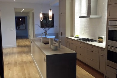 Example of a minimalist kitchen design in New York with concrete countertops and gray countertops
