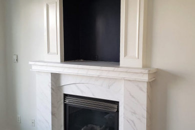 Inspiration for a mid-sized contemporary formal and enclosed laminate floor and brown floor living room remodel in Vancouver with white walls, a standard fireplace and a stone fireplace
