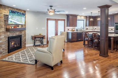 Open concept kitchen - large craftsman u-shaped medium tone wood floor open concept kitchen idea in Chicago with an undermount sink, shaker cabinets, dark wood cabinets, quartzite countertops, multicolored backsplash, cement tile backsplash, stainless steel appliances and an island