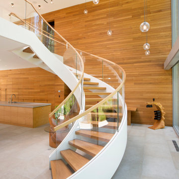 Entry Featuring Curved Staircase and Pendant Lighting
