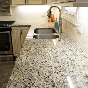 Beige Kitchen with Extra Large Island, Tile Backsplash and Granite Countertops