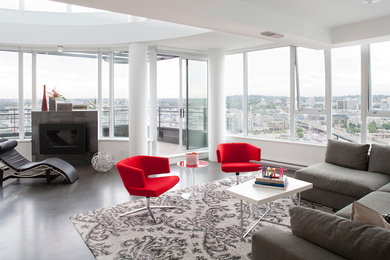 Inspiration for a large modern open concept concrete floor living room remodel in Toronto with white walls, a standard fireplace and a tile fireplace