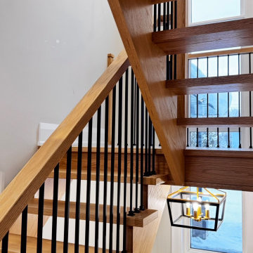 Modern White Oak Open Riser Staircase with Black Metal Balusters