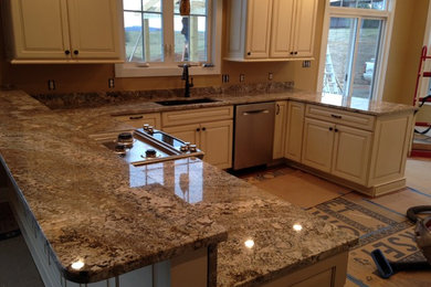 Inspiration for a craftsman u-shaped eat-in kitchen remodel in Other with an undermount sink, distressed cabinets, granite countertops and stainless steel appliances