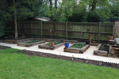 Raised herb and vegetable beds with Espalier Apple and Pear trees