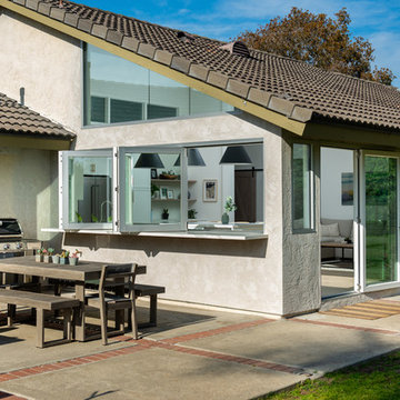 AG BiFold Patio Door & Window Pairing Connects All-White Kitchen to the Outdoors