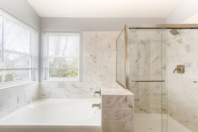 Inspiration for a mid-sized transitional master bathroom in Columbus with furniture-like cabinets, turquoise cabinets, a drop-in tub, an alcove shower, white tile, marble, grey walls, porcelain floors, an undermount sink, marble benchtops, brown floor and a sliding shower screen.