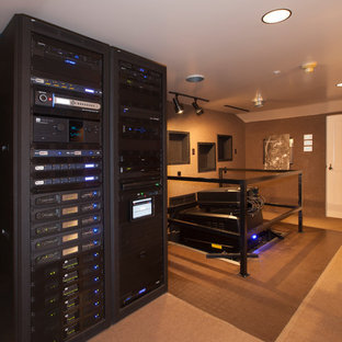 Photo of an expansive rustic open plan home cinema in Los Angeles with brown walls, carpet, a projector screen and brown floors.