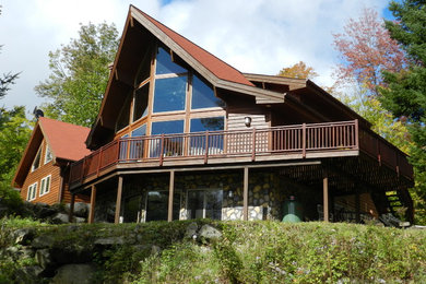 Large traditional brown two-story wood house exterior idea in Montreal with a shingle roof