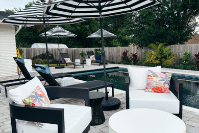 Patio - mid-sized coastal backyard stone patio idea in Houston