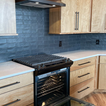 Angled Kitchen Design with Slab Style Cabinets in Pecan Stain