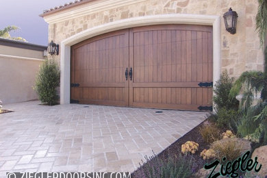 Design ideas for a large mediterranean attached double garage in Orange County.