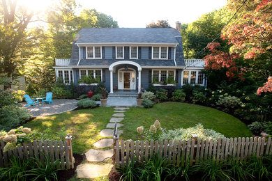 Photo of a mid-sized traditional front yard full sun garden in New York with natural stone pavers.
