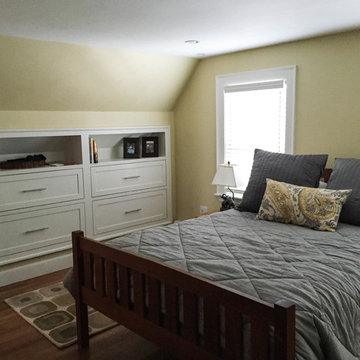 Bedroom with built in bureau drawers in knee walls.
