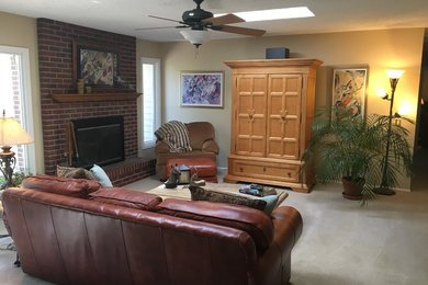 Inspiration for a medium sized classic enclosed games room in Denver with beige walls, carpet, a standard fireplace, a brick fireplace surround, a concealed tv and white floors.