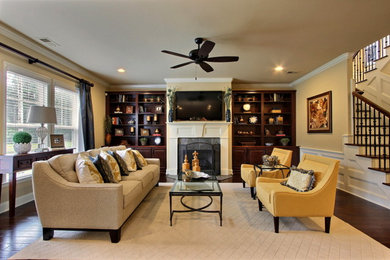 Large elegant open concept dark wood floor living room photo in Atlanta with yellow walls, a standard fireplace, a tile fireplace and a wall-mounted tv