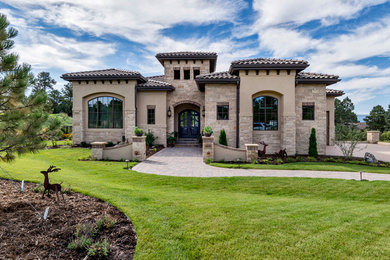 Huge mediterranean beige two-story mixed siding house exterior idea in Denver with a hip roof and a tile roof