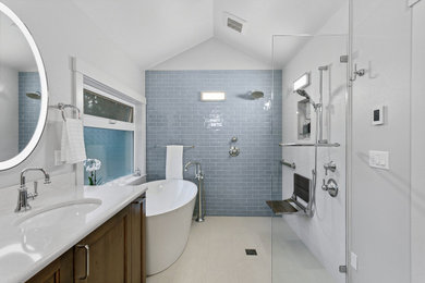 Bathroom - large master blue tile and porcelain tile ceramic tile, beige floor, double-sink and vaulted ceiling bathroom idea in Seattle with recessed-panel cabinets, brown cabinets, a bidet, white walls, an undermount sink, quartz countertops, a built-in vanity and white countertops