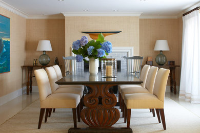 Mid-sized traditional separate dining room in Boston with beige walls, porcelain floors, a standard fireplace, a brick fireplace surround and beige floor.