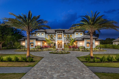 Inspiration for a timeless white two-story house exterior remodel in Miami with a hip roof