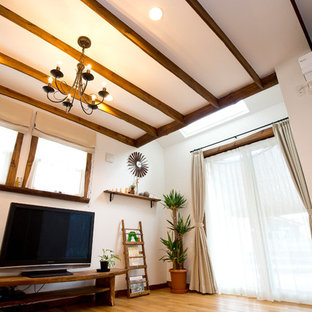 Imagen de salón abierto, mediterráneo, sin chimenea, con paredes azules, suelo de madera en tonos medios y televisor independiente