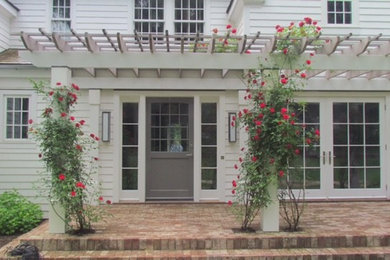 Example of a large white two-story wood exterior home design in New York