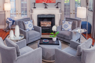 Inspiration for a mid-sized transitional enclosed medium tone wood floor living room remodel in Columbus with gray walls, a standard fireplace, a stone fireplace and no tv