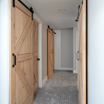 Basement with barn door style hardware and knotty alder doors