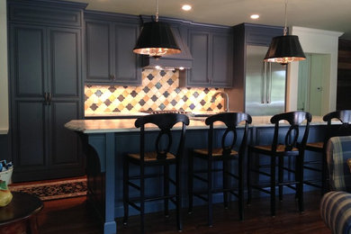 Inspiration for a mid-sized timeless single-wall medium tone wood floor kitchen remodel in St Louis with a double-bowl sink, beaded inset cabinets, blue cabinets, marble countertops, yellow backsplash, ceramic backsplash, stainless steel appliances and an island