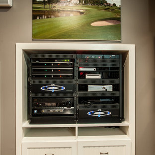 Inspiration for a small contemporary enclosed carpeted home theater remodel in Charlotte with beige walls and a media wall