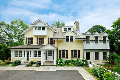 Example of a classic yellow three-story exterior home design in New York