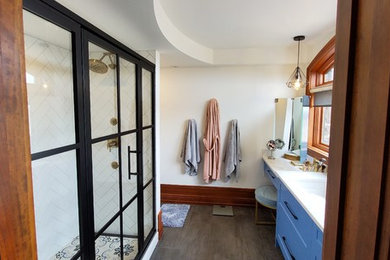 Large minimalist kids' white tile and subway tile ceramic tile and gray floor alcove shower photo in Calgary with shaker cabinets, blue cabinets, a two-piece toilet, white walls, an undermount sink, quartz countertops, a hinged shower door and white countertops