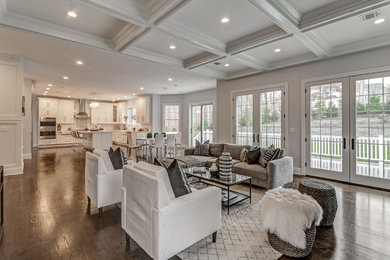 Example of a large classic open concept dark wood floor and brown floor family room design in New York with gray walls, a standard fireplace and a stone fireplace
