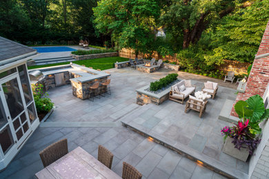 Large elegant backyard patio photo in Boston with a fire pit