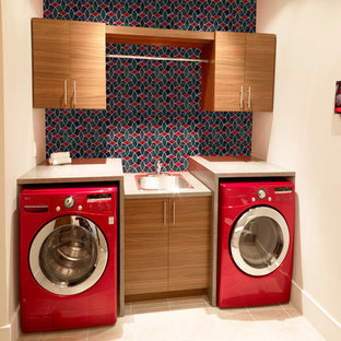 Medium sized modern u-shaped separated utility room in Gold Coast - Tweed with a single-bowl sink, brown cabinets, terrazzo worktops, porcelain flooring, a stacked washer and dryer, beige floors, beige worktops, beaded cabinets and red walls.