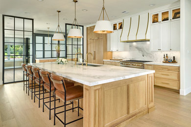 Open concept kitchen - huge transitional single-wall light wood floor open concept kitchen idea in Dallas with an undermount sink, recessed-panel cabinets, light wood cabinets, marble countertops, paneled appliances, an island and white countertops