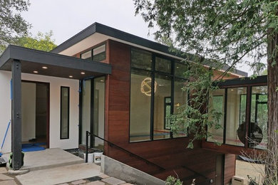 Large 1950s multicolored one-story mixed siding house exterior photo in San Francisco with a shed roof