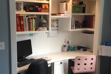 Example of a small trendy gender-neutral dark wood floor and brown floor reach-in closet design in Other with open cabinets and white cabinets