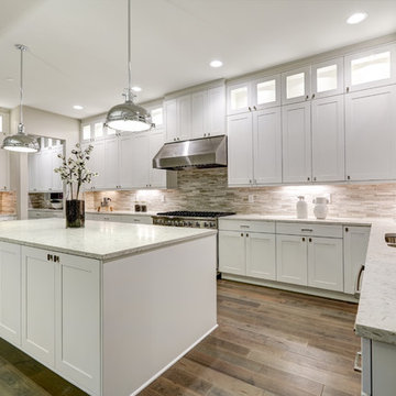 Beautiful kitchen in luxury home with island, pendant lights, cabinets and more