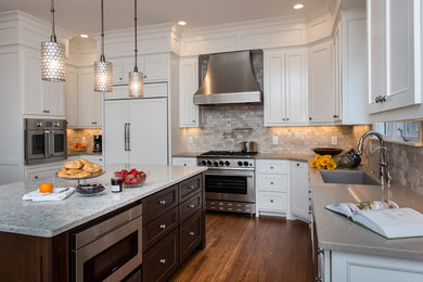 Open concept kitchen - large transitional medium tone wood floor and brown floor open concept kitchen idea in Raleigh with a double-bowl sink, flat-panel cabinets, white cabinets, quartz countertops, gray backsplash, stone tile backsplash, stainless steel appliances and no island