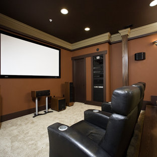 Home theater - traditional home theater idea in Seattle with red walls