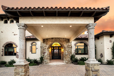 Inspiration for an expansive mediterranean entryway in Austin with beige walls and a single front door.