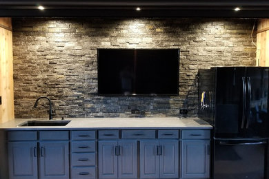 Mid-sized mountain style backyard concrete patio kitchen photo in Dallas with a roof extension