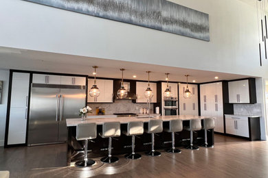 Example of a huge trendy galley open concept kitchen design in Calgary with two islands