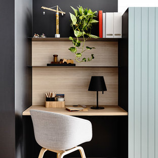 Design ideas for a small modern study in Melbourne with black walls and a built-in desk.
