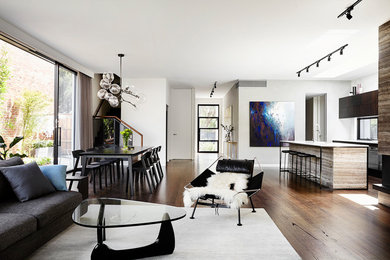 This is an example of a mid-sized contemporary open concept living room in Melbourne with dark hardwood floors and brown floor.