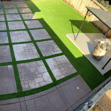 Hollister Stamped Concrete Backyard with Synthetic Grass